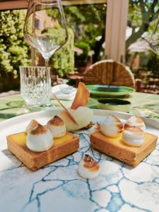 two slices of bread with marshmallows and a glass of wine at Hôtel La Pérouse Nice Baie des Anges in Nice