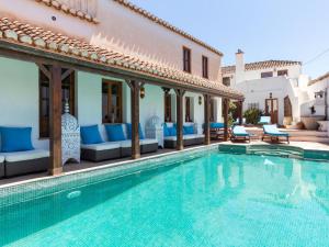 a villa with a swimming pool and a house at Molino Bajo in Melegis