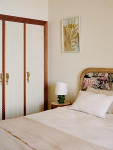 a bedroom with a white bed with a glass door at Hôtel La Pérouse Nice Baie des Anges - Recently fully renovated in Nice