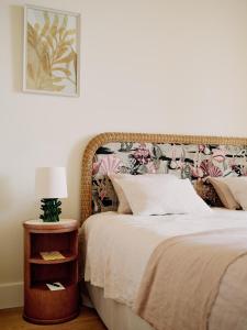 a bedroom with a bed and a table with a lamp at Hôtel La Pérouse Nice Baie des Anges in Nice