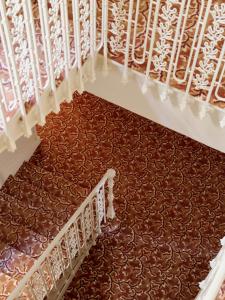 a view from the top of a staircase with brown carpet at Hôtel La Pérouse Nice Baie des Anges in Nice