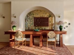a dining room with a wooden table and chairs at Hôtel La Pérouse Nice Baie des Anges in Nice