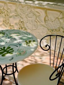 a table and two chairs next to a table and a plate at Hôtel La Pérouse Nice Baie des Anges in Nice
