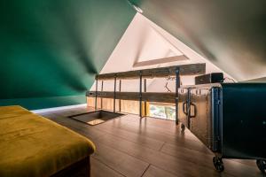 an attic room with a bed and a window at Domandi mountain holiday lodges in Przesieka
