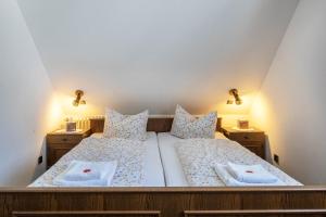 a bedroom with two beds and two night stands at Waldesruh in Titisee-Neustadt