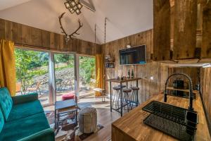 a living room with a couch and a table at Domandi mountain holiday lodges in Przesieka