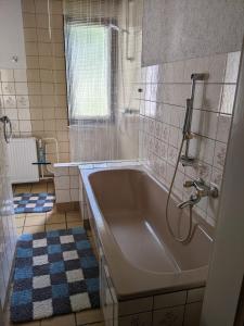a bathroom with a large tub and a shower at Ferienwohnung Am Park in Greiz