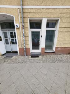 two doors of a building with a person standing outside at Apartment Pette C40 in Berlin