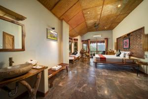 a bedroom with a bed and a sink in a room at Puluong Retreat in Pu Luong