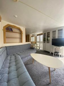 a living room with a couch and a table at Dulczetto Camp in Jastarnia