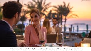 a group of people sitting at a table with wine glasses at Jumeirah Al Naseem Dubai in Dubai