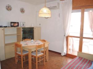 - une cuisine avec une table et des chaises dans la chambre dans l'établissement Warm two-room flat with terrace near the beach, à Bibione
