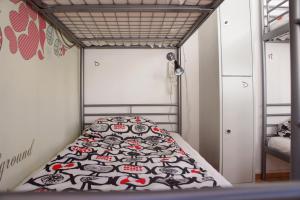 a bed in a room with a bedspread on it at SweetDream Guesthouse in Helsinki