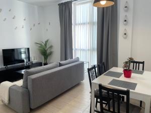 a living room with a couch and a table at Málaga Center Flat. Carmen City Center Roof-Terrace Boutique in Málaga