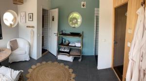 a living room with a door and a room with a rug at Glamping i Döshult in Viken
