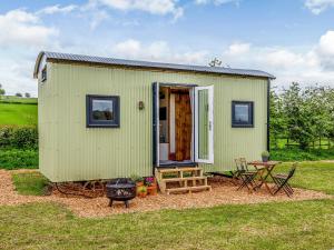 a green tiny house with a table and a grill at Foxglove - Uk37639 in Bradbourne
