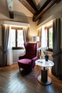 a living room with a purple chair and a table at Radisson Collection Hotel, Palazzo Nani Venice in Venice