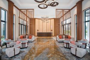 a lobby with a waiting room with chairs and a podium at Angsana Ho Tram in Ho Tram