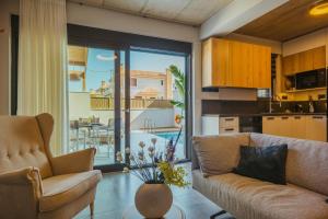 salon z kanapą i stołem z kwiatami w obiekcie Anemmaro Villa 3 in Crete w mieście Gournes