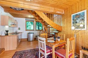 eine Küche und ein Esszimmer mit einem Tisch und einer Wendeltreppe in der Unterkunft Landhaus Graf in Kniebis