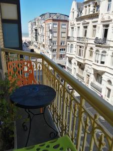 a table and chairs on a balcony with a view of a city at Villa Stella Maris in Ostend +15 photos