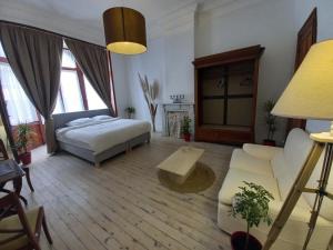 a bedroom with a bed and a couch at Villa Stella Maris in Ostend