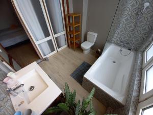 a bathroom with a sink and a tub and a toilet at Villa Stella Maris in Ostend