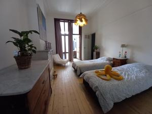 a bedroom with two beds with a yellow pacifier on the floor at Villa Stella Maris in Ostend