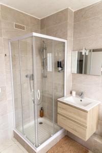 a bathroom with a shower and a sink at Le Domaine de la Désirée in Lisieux