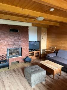 a living room with a couch and a fireplace at Chaty Lipa in Levoča