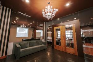 a living room with a couch and a chandelier at Zenit Hall 88 Studios in Salamanca