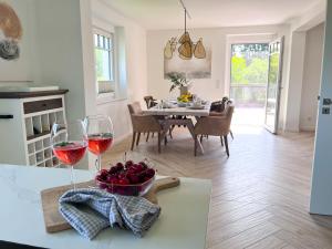 a kitchen with a table with two glasses of wine at Relaxhome in Hallschlag