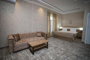a living room with a couch and a bed at LakeSide Hotel & Spa in Gabala