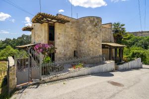a stone house with a fence and flowers on it at Isatour - Ninho D' Águia in Águeda