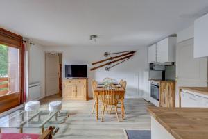 a kitchen and dining room with a table and chairs at Le Goléron des Evettes in Flumet