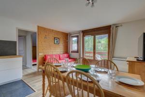 a kitchen and dining room with a table and chairs at Le Goléron des Evettes in Flumet