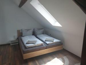 a bedroom with a bed in a attic at Pension am Sonnenhof in Schmalkalden