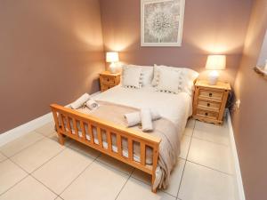 a bedroom with a bed and two night stands at 4 Pheasant Lane in Sheffield