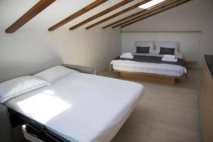 a bedroom with two beds in a room at Dea Del Mar Apartments in Izola