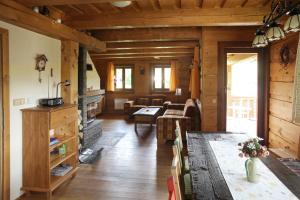 a living room with a table and a fireplace at Drevenica Čakanka a Nezábudka in Terchová