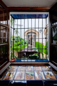 a window with a view of a house at Ático con encanto en Sierpes in Seville