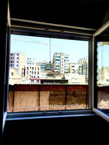 a view of a city from a window at Modiano Studio ΙΙ By Socrates Junior Houses in Thessaloniki