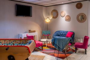 a living room with a pool table and chairs at ibis Styles Blois Centre Gare in Blois
