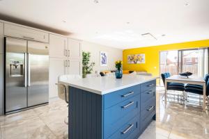 a kitchen with a blue and white island in a room at Park House - FOUR star luxury with parking and WI-FI in Belfast