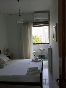 Postel nebo postele na pokoji v ubytování ΑLEXANDRAS HOUSE