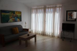 a living room with a couch and a coffee table at ÁTICO CENTRO in Yecla