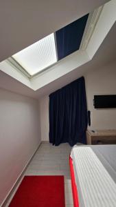a bedroom with a bed and a skylight at Apartments Villa Alba in Dubrovnik