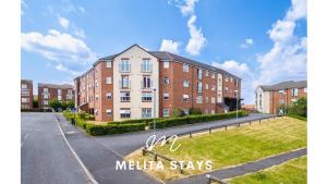 an apartment building in the middle of a street at Spacious 2 bedroom apartment with gated parking in Solihull