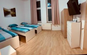 a small room with two beds and a tv at Gelsenkirchen, 2-Zimmer Wohnung , 6 Person in Gelsenkirchen