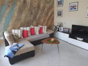 a living room with a couch and a table at Appartamenti Donato in Peschiera del Garda